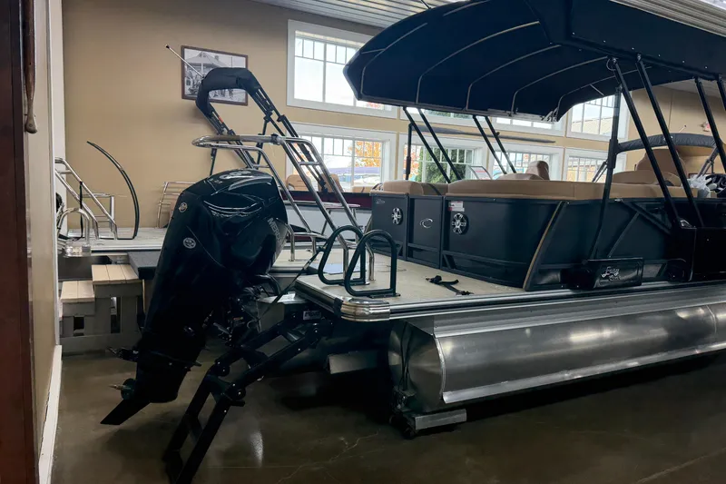 Slide: The Image of 2026 Crest Caribbean 230 SLC pontoon boat with outboard motor in showroom. - 9