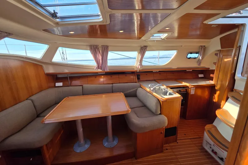 Slide: The Image of Interior of 1999 Jeanneau Sun Odyssey 40 DS sailboat with wood finish and seating area. - 11