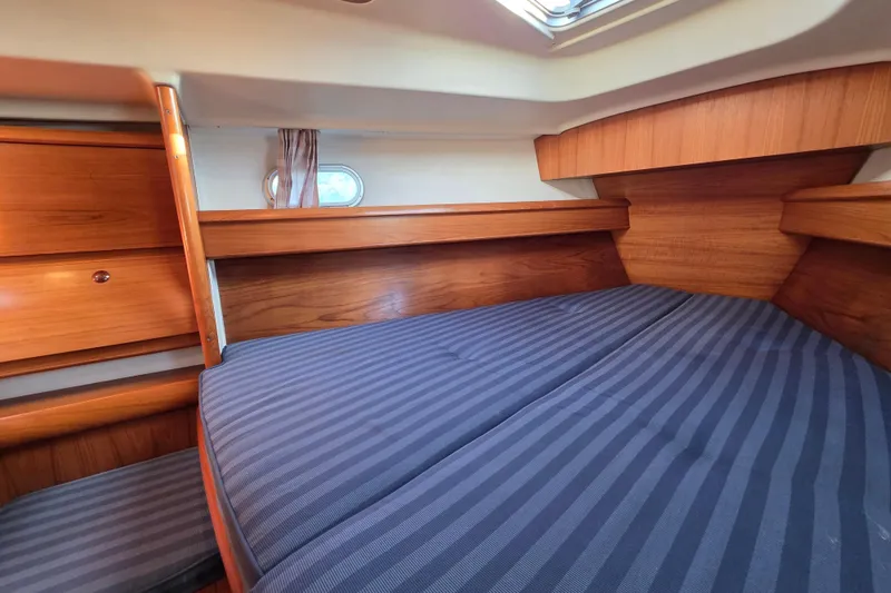 Slide: The Image of Cozy cabin interior of 1999 Jeanneau Sun Odyssey 40 DS with striped bedding. - 14