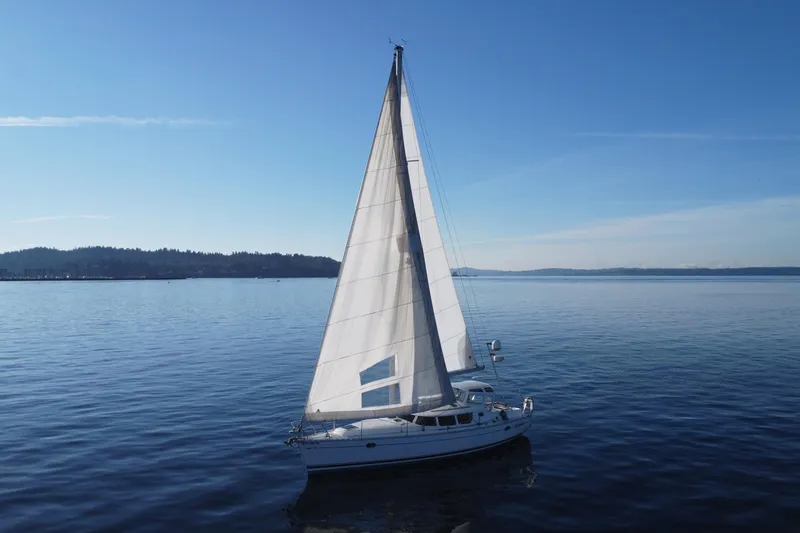 Slide: The Image of Sailboat Jeanneau Sun Odyssey 40 DS, 1999, gliding on calm blue waters under clear skies. - 22