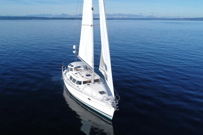 Slide: The Image of Sailing yacht Jeanneau Sun Odyssey 40 DS, 1999, on calm blue waters. - 23