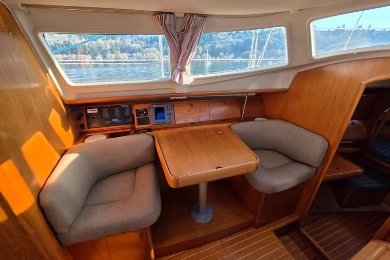 Slide: The Image of Interior of 1999 Jeanneau Sun Odyssey 40 DS sailboat with cozy seating and navigation equipment. - 7