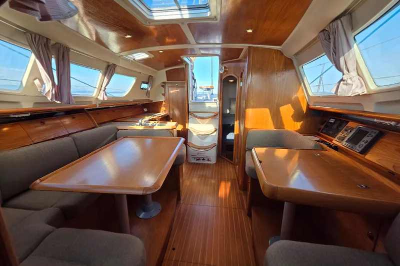 Slide: The Image of Interior of 1999 Jeanneau Sun Odyssey 40 DS sailboat, featuring wood finish and seating area. - 8