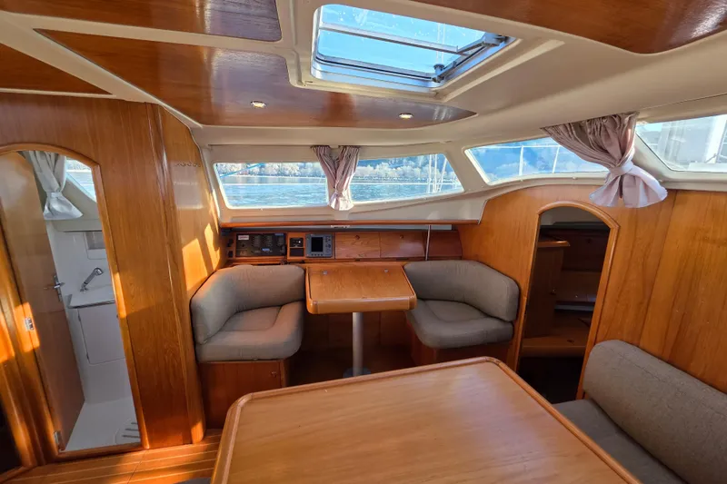 Slide: The Image of Interior of 1999 Jeanneau Sun Odyssey 40 DS sailboat with wood finish and seating area. - 9