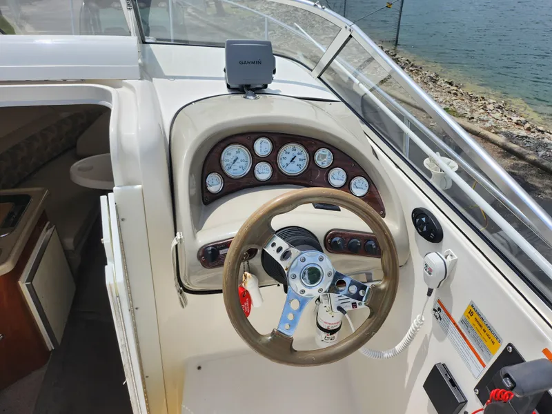 Slide: The Image of 2008 Glastron GT 249 boat dashboard with steering wheel and gauges. - 12