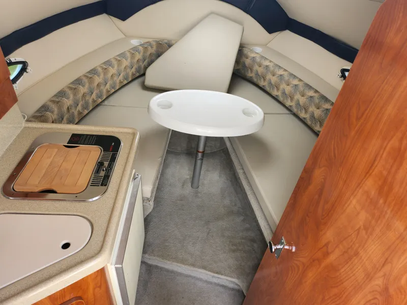 Slide: The Image of 2008 Glastron GT 249 boat interior with kitchenette and seating area. - 20