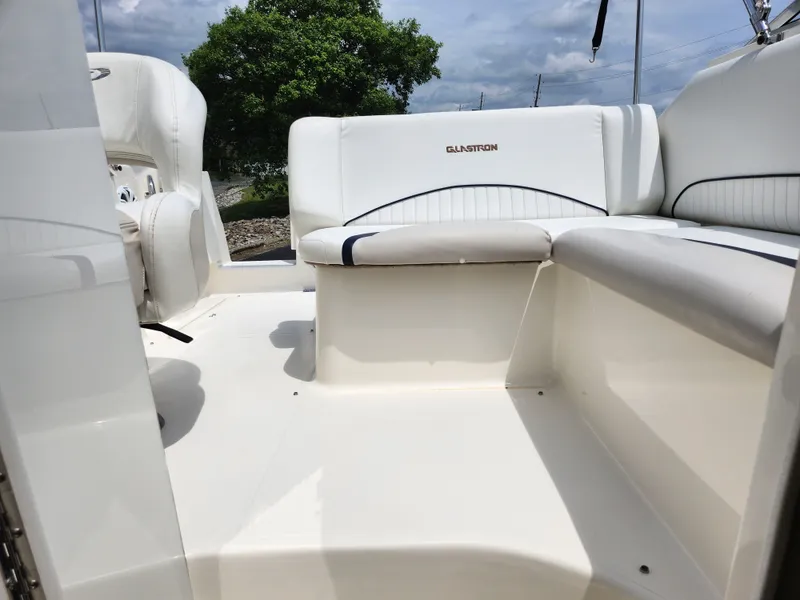 Slide: The Image of 2008 Glastron GT 249 boat interior with white seating and open deck. - 26