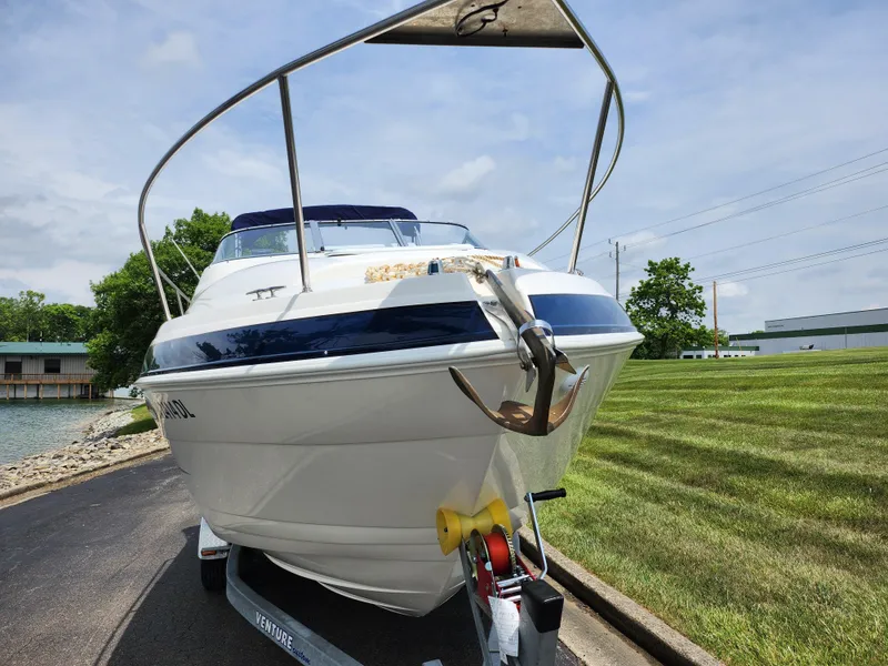 Slide: The Image of 2008 Glastron GT 249 boat on trailer, front view, outdoors. - 6