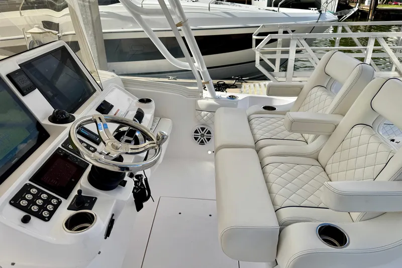 Slide: The Image of 2022 Intrepid 409 Valor helm with dual seats, steering wheel, and navigation screens. - 10