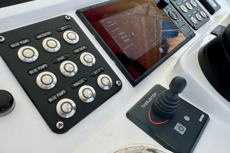 Slide: The Image of Control panel of 2022 Intrepid 409 Valor boat with buttons and joystick. - 11