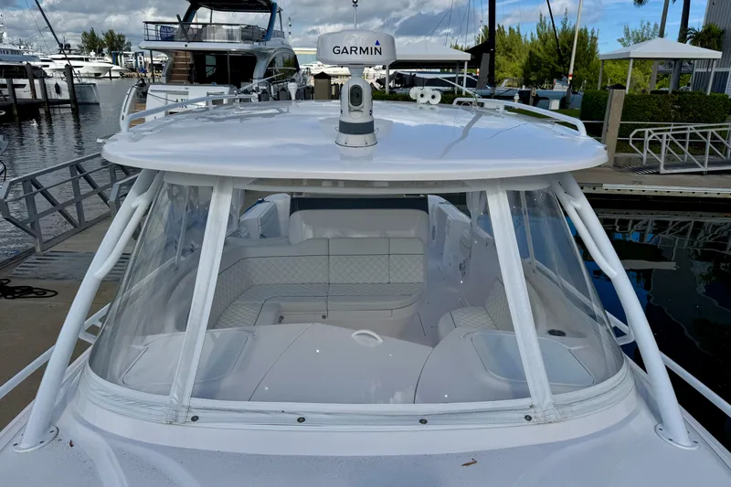 Slide: The Image of 2022 Intrepid 409 Valor boat docked, featuring a sleek design and Garmin equipment. - 19