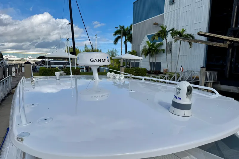 Slide: The Image of 2022 Intrepid 409 Valor boat with Garmin and FLIR equipment at a marina. - 20