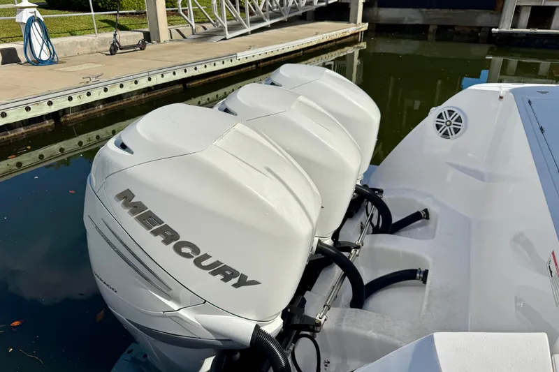 Slide: The Image of 2022 Intrepid 409 Valor with Mercury outboard engines docked at marina. - 22