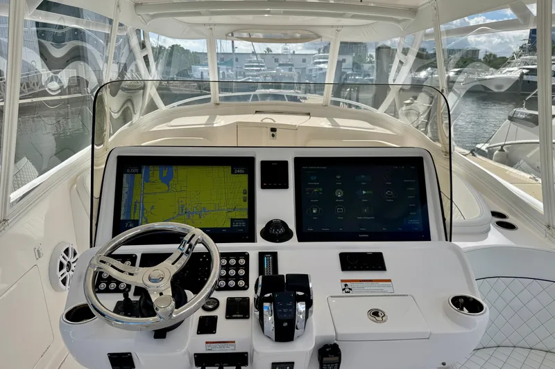 Slide: The Image of 2022 Intrepid 409 Valor boat dashboard with navigation screens and steering wheel. - 5