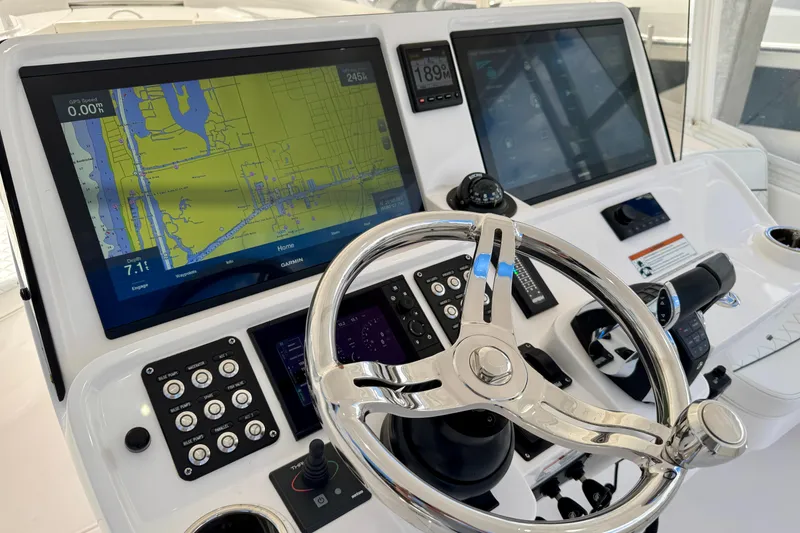 Slide: The Image of Helm of 2022 Intrepid 409 Valor featuring advanced navigation displays and controls. - 6