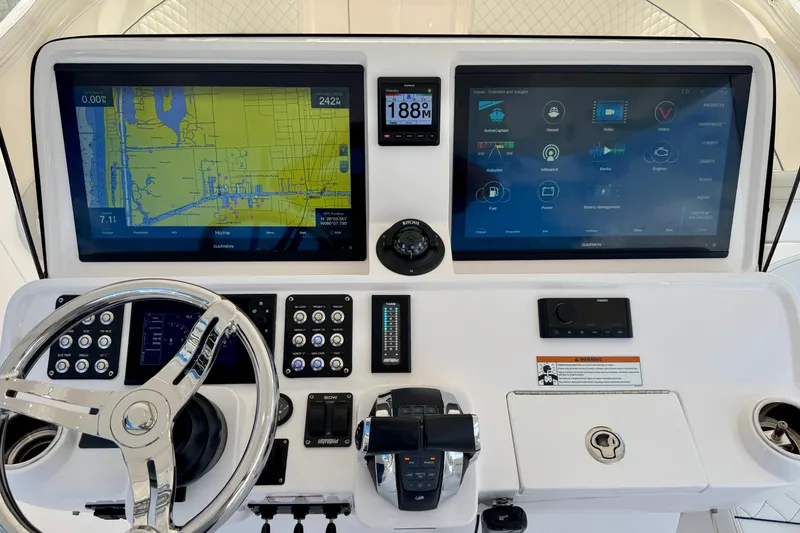 Slide: The Image of 2022 Intrepid 409 Valor helm with dual Garmin displays and advanced navigation controls. - 8
