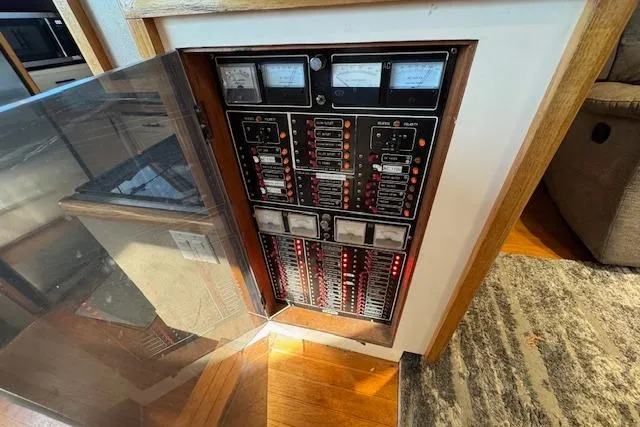 Slide: The Image of Electrical panel inside 1985 Symbol 58 Cockpit Motor Yacht, featuring gauges and switches. - 11