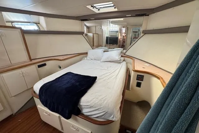 Slide: The Image of Luxurious bedroom interior of 1985 Symbol 58 Cockpit Motor Yacht with cozy bedding. - 20