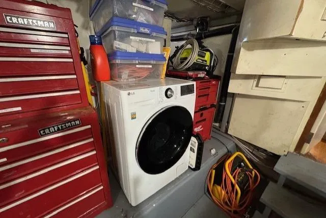 Slide: The Image of Laundry area in 1985 Symbol 58 Cockpit Motor Yacht with toolboxes and storage bins. - 23