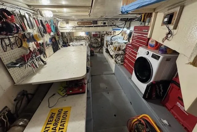 Slide: The Image of Engine room of 1985 Symbol 58 Cockpit Motor Yacht with tools and washer. - 24