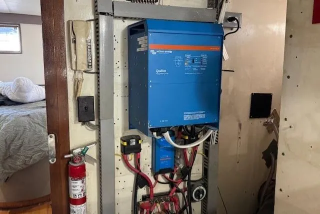 Slide: The Image of Electrical panel in 1985 Symbol 58 Cockpit Motor Yacht with fire extinguisher and wiring. - 25