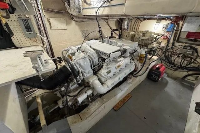 Slide: The Image of Engine room of a 1985 Symbol 58 Cockpit Motor Yacht, showcasing machinery and equipment. - 26