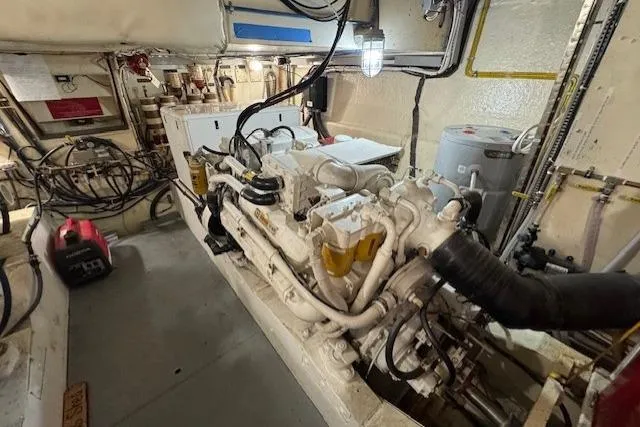 Slide: The Image of Engine room of 1985 Symbol 58 Cockpit Motor Yacht with visible machinery and wiring. - 27