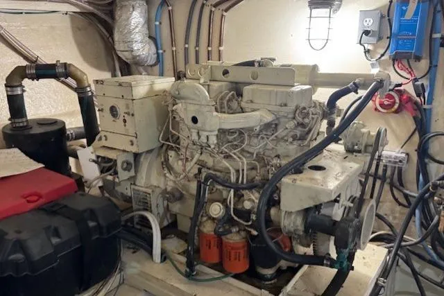 Slide: The Image of Engine room of a 1985 Symbol 58 Cockpit Motor Yacht, showcasing mechanical components. - 28