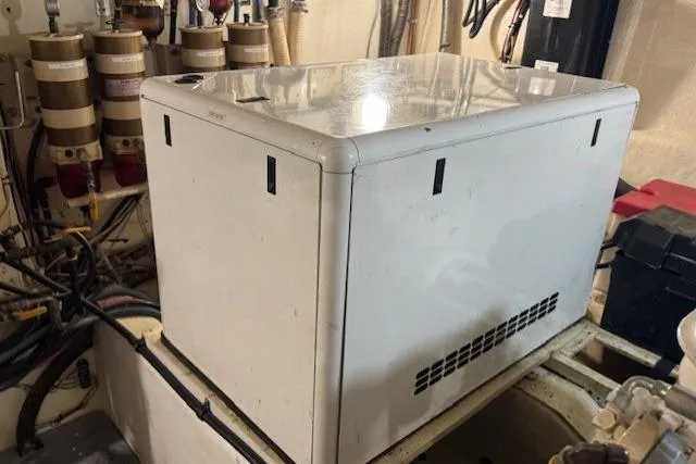 Slide: The Image of Engine room of 1985 Symbol 58 Cockpit Motor Yacht with generator and equipment. - 29