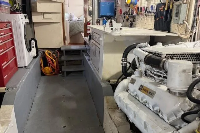 Slide: The Image of Engine room of 1985 Symbol 58 Cockpit Motor Yacht with tools and equipment. - 32