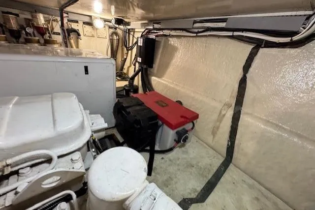 Slide: The Image of Engine room of 1985 Symbol 58 Cockpit Motor Yacht with visible machinery and wiring. - 36