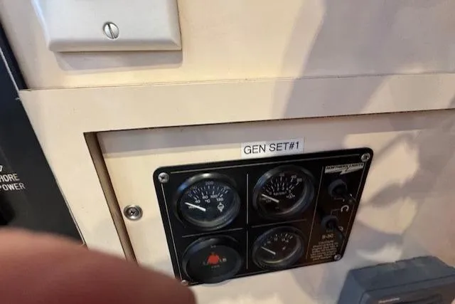 Slide: The Image of Control panel of a 1985 Symbol 58 Cockpit Motor Yacht, labeled "GEN SET #1". - 38