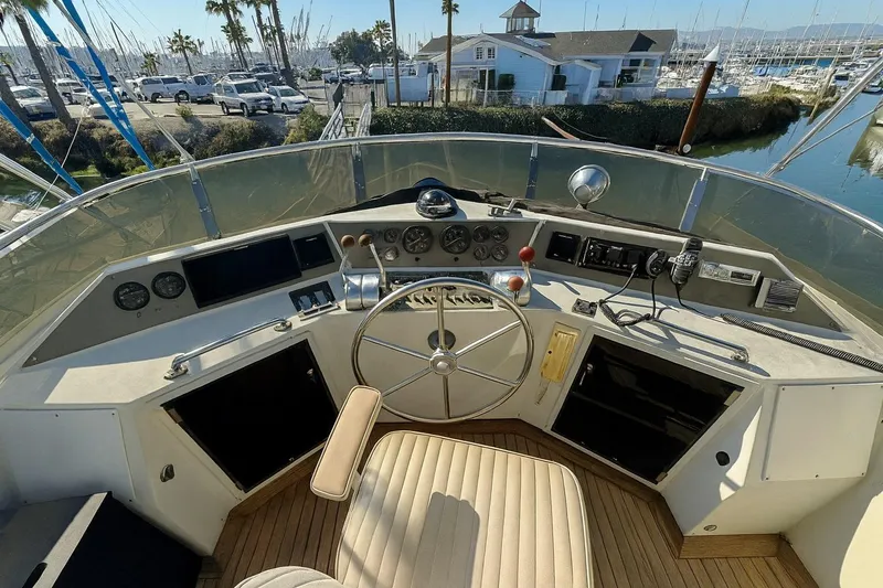 Slide: The Image of Cockpit of 1985 Symbol 58 Cockpit Motor Yacht with steering wheel and control panel. - 40