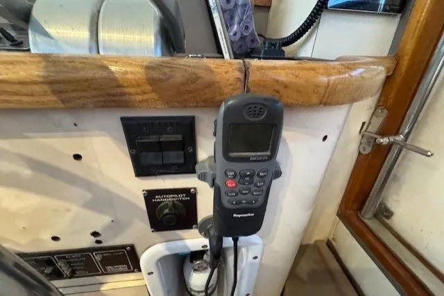 Slide: The Image of 1985 Symbol 58 Cockpit Motor Yacht control panel with radio and switches. - 43