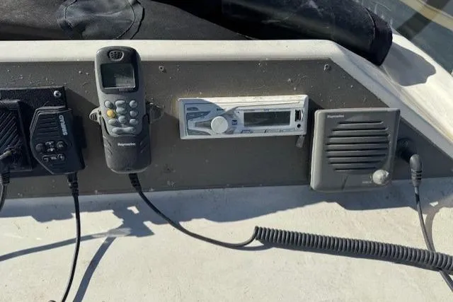 Slide: The Image of Control panel of a 1985 Symbol 58 Cockpit Motor Yacht with communication devices. - 44