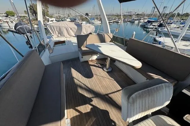 Slide: The Image of 1985 Symbol 58 Cockpit Motor Yacht with spacious outdoor seating and marina view. - 46