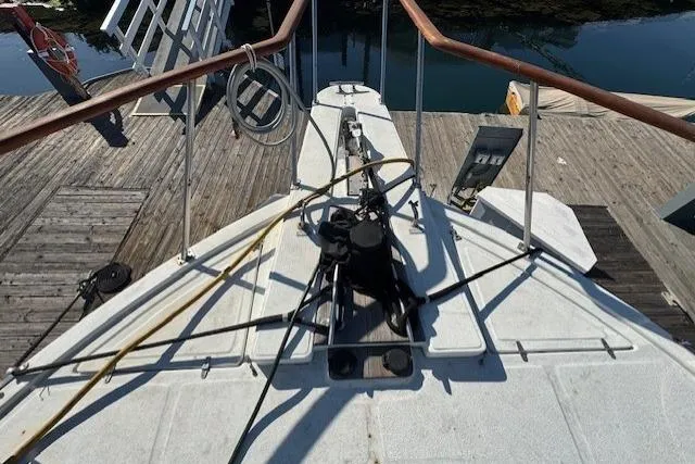 Slide: The Image of 1985 Symbol 58 Cockpit Motor Yacht bow view at dock, showcasing deck equipment. - 47