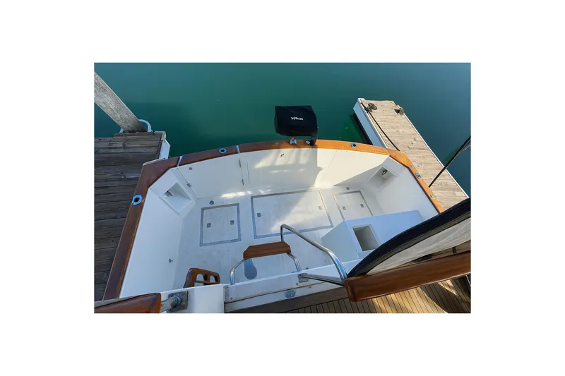 Slide: The Image of 1985 Symbol 58 Cockpit Motor Yacht docked, showcasing spacious cockpit and wooden accents. - 49