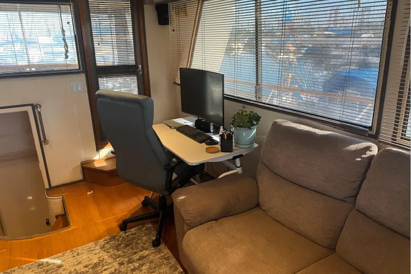 Slide: The Image of Interior of 1985 Symbol 58 Cockpit Motor Yacht with desk, chair, and sofa. - 6