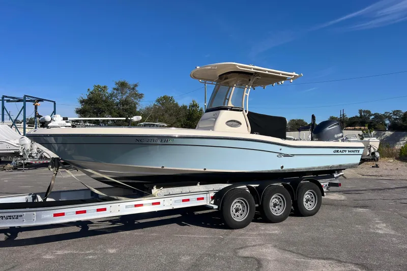 The Image of 2018 Grady-White 251 Coastal Explorer boat on a trailer under clear blue sky. - 1