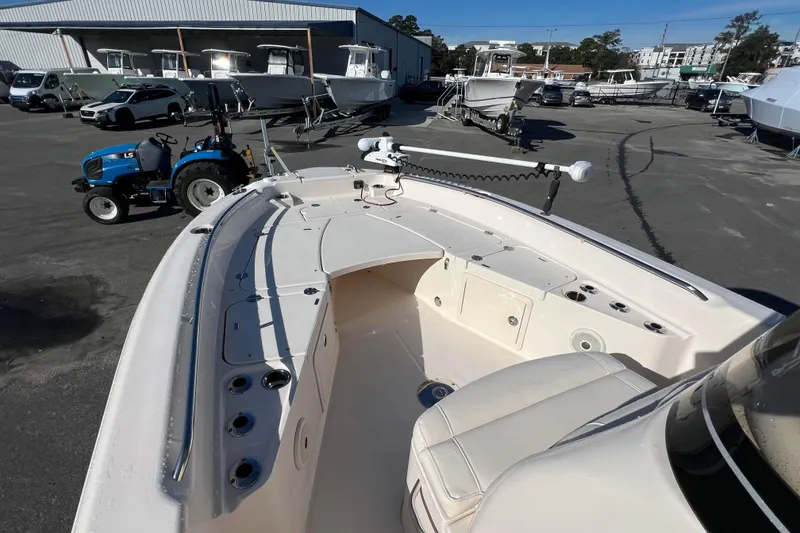 Slide: The Image of 2018 Grady-White 251 Coastal Explorer boat in a marina with surrounding vehicles. - 8