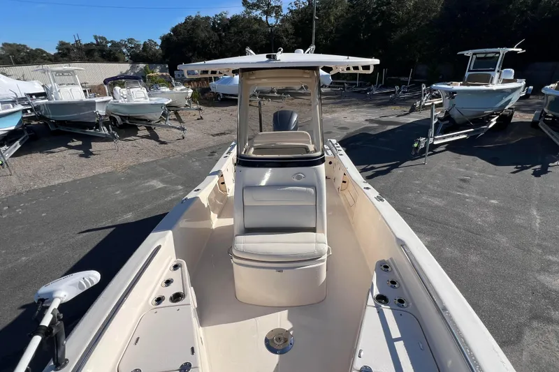 Slide: The Image of 2018 Grady-White 251 Coastal Explorer boat, parked outdoors, showcasing spacious deck and seating. - 9