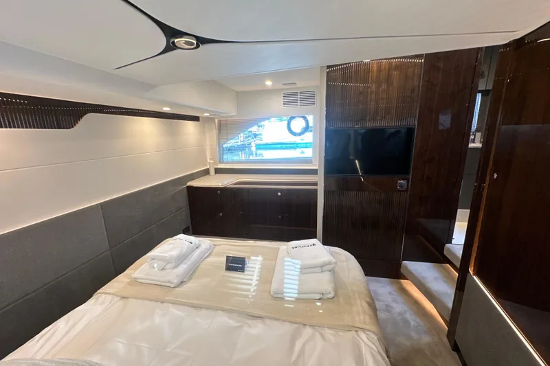 Slide: The Image of Luxurious Fairline Targa 47 GT yacht interior, featuring elegant seating and a wooden table with flowers. - 48