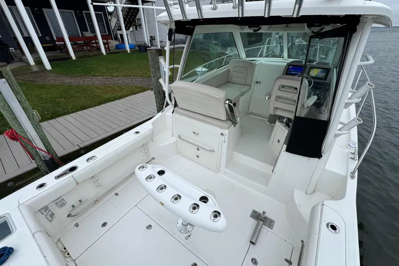Slide: The Image of 2016 Boston Whaler 315 Conquest boat interior with seating and navigation equipment. - 14