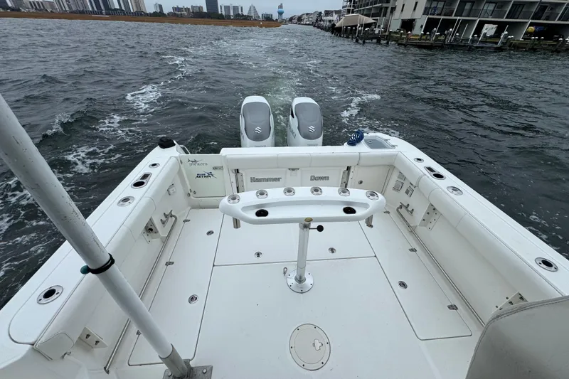 Slide: The Image of 2016 Boston Whaler 315 Conquest boat deck with dual engines on water. - 18