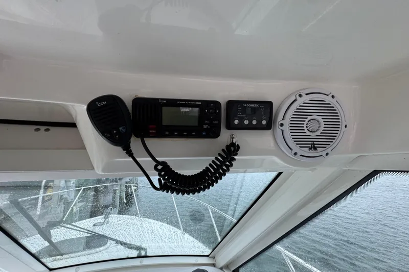 Slide: The Image of 2016 Boston Whaler 315 Conquest dashboard with radio, controls, and speaker. - 20