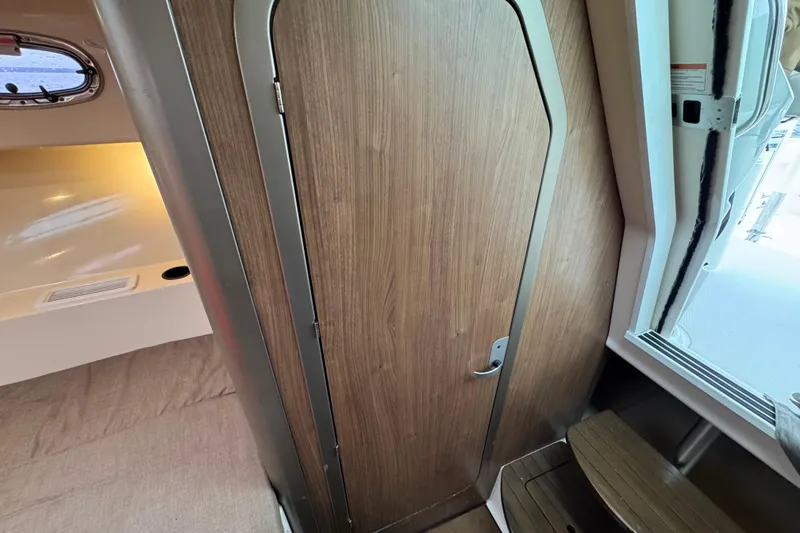 Slide: The Image of Interior cabin of 2016 Boston Whaler 315 Conquest with wooden door and window. - 29