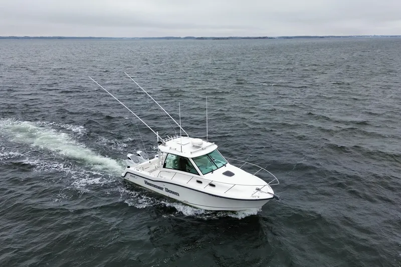 Slide: The Image of 2016 Boston Whaler 315 Conquest cruising on open water. - 4