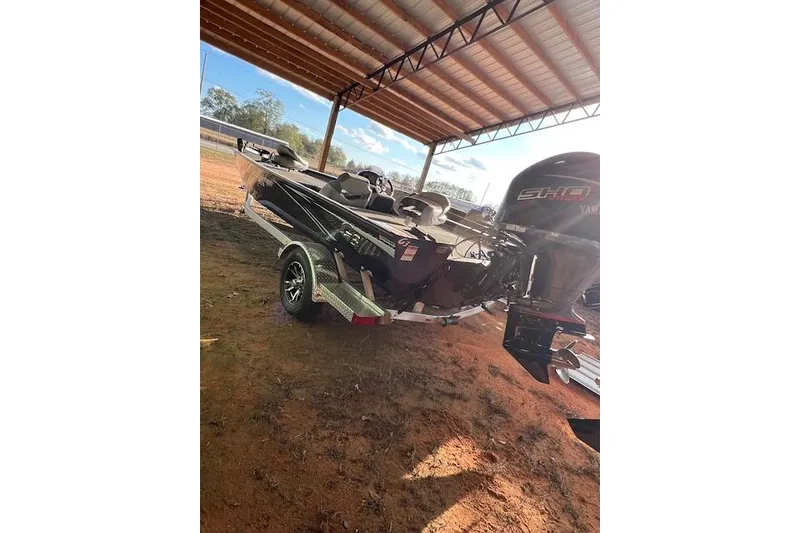 The Image of 2025 G3 Sportsman 1910 boat on trailer under a metal canopy. - 1