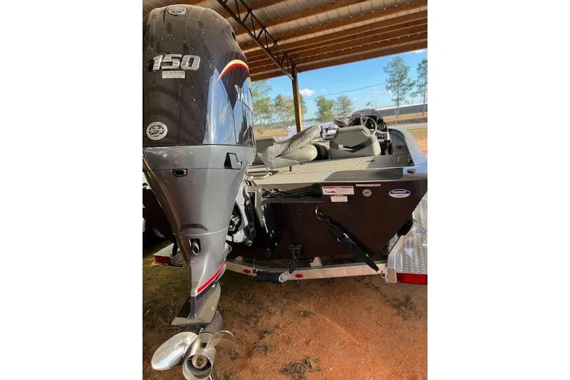 Slide: The Image of 2025 G3 Sportsman 1910 boat with 150 HP outboard motor, parked under shelter. - 6